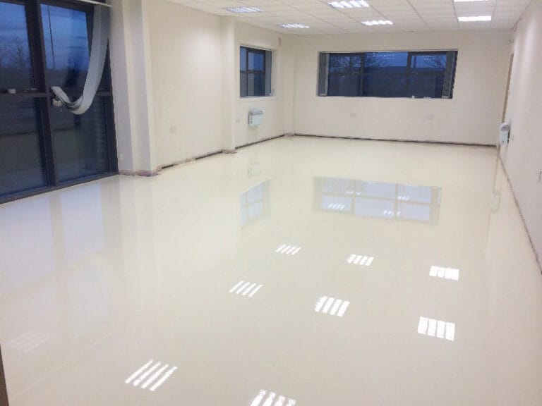 Glossy Achtis APU 45 resin topcoat applied to flooring in an empty boardroom