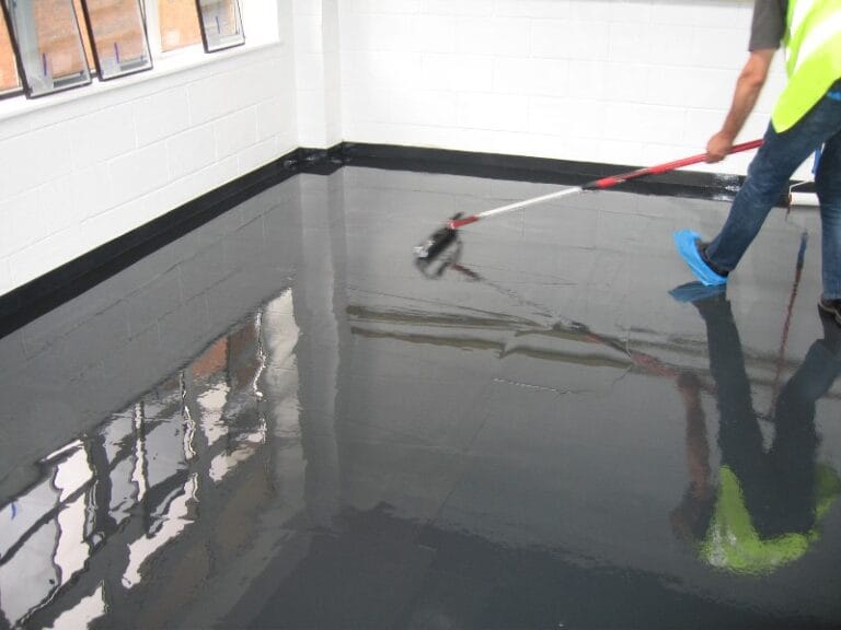 Operative applying Achtis EP 104 protective coating in a cafeteria space