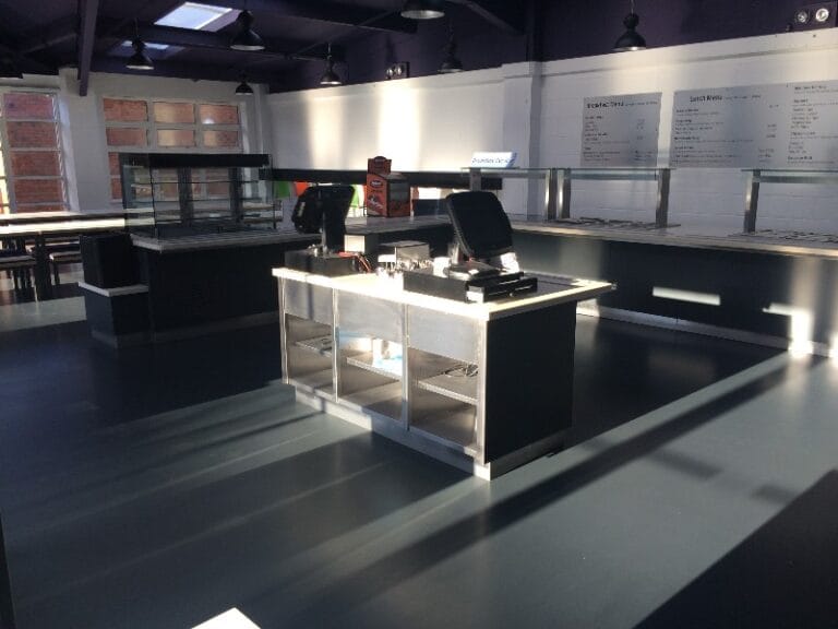 Commercial cafeteria floor with dark finish, six months after Achtis APU 46 application
