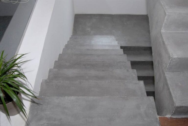 Light grey Microcement stairs descending, photographed from top step