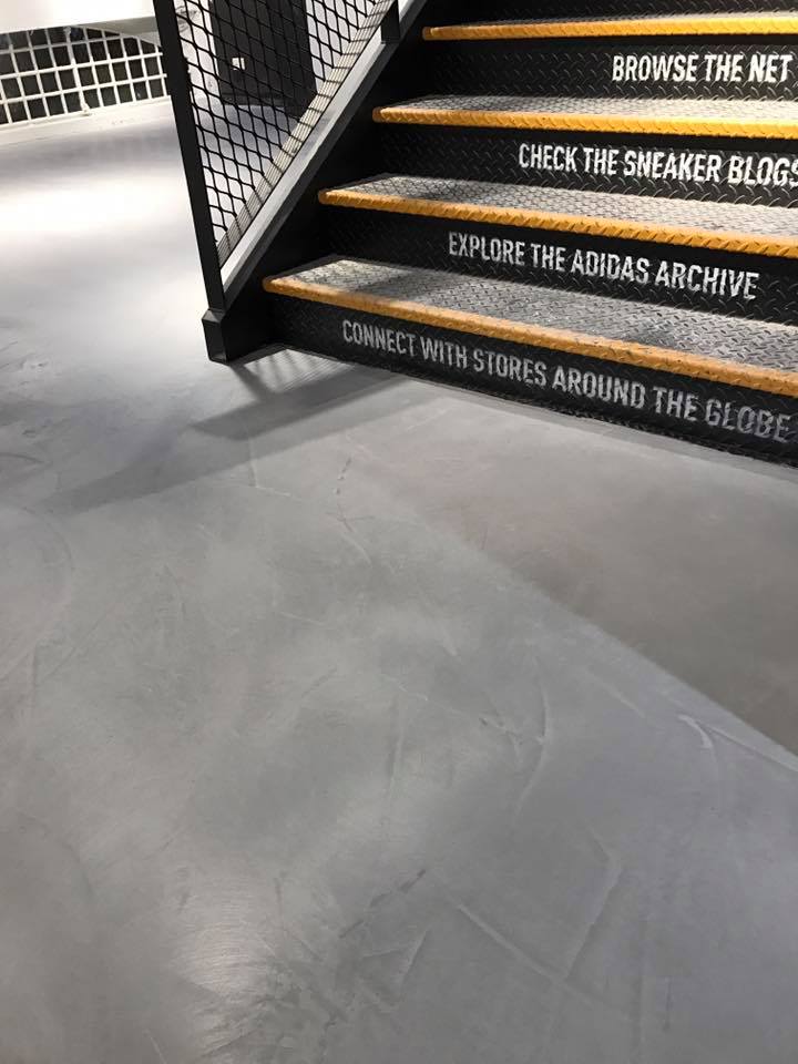 Close-up detail of Politura Microcement flooring in the Adidas retail store