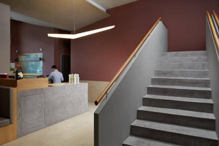 Grey Microcement staircase and reception counter in a bar