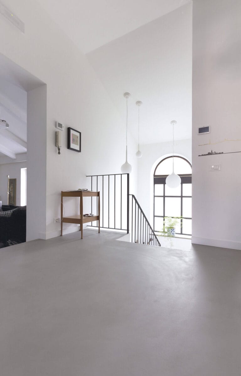 ErreLAB ErreFAST light neutral floor in spacious loft with stairs, windows and open-plan layout