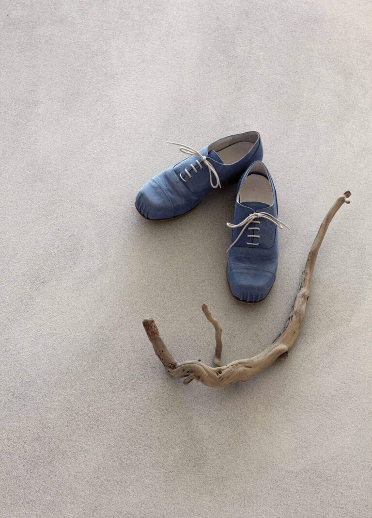 ErreLAB Pietra Continua Basalto light floor with blue leather shoes and natural driftwood styling