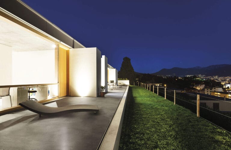 ErreLAB Spatolato Outdoor hotel terrace with evening city lights and views
