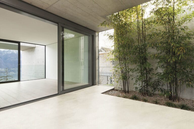 ErreLAB Spatolato Outdoor finish on outdoor terrace with glass entrance