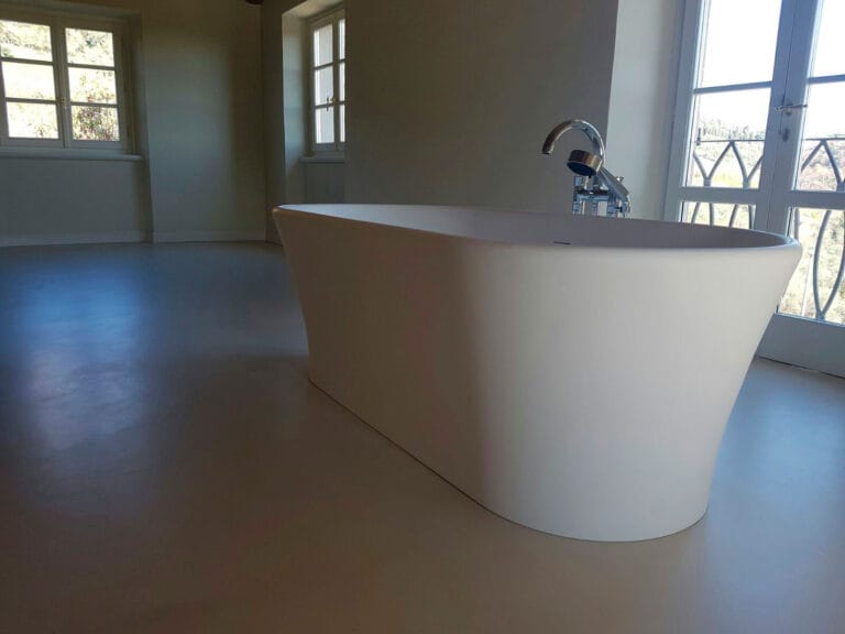 ErreLAB Spatolato flooring in bathroom with freestanding white tub and contemporary light finish