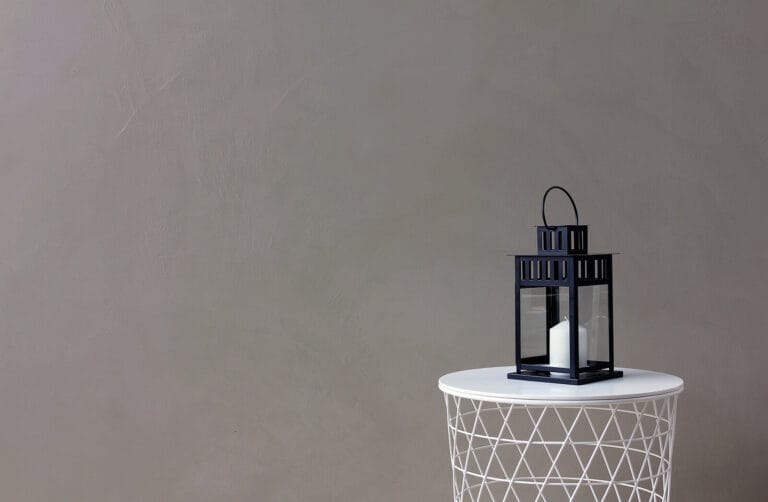 Grey ErreLAB Spatolato wall finish with wire basket and decorative lantern