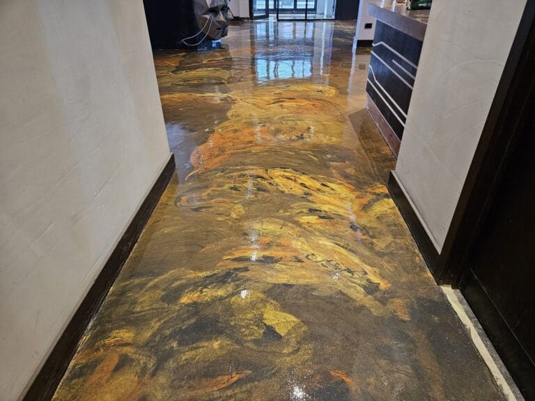 Metallic gold and charcoal decorative floor finish applied in a corridor space
